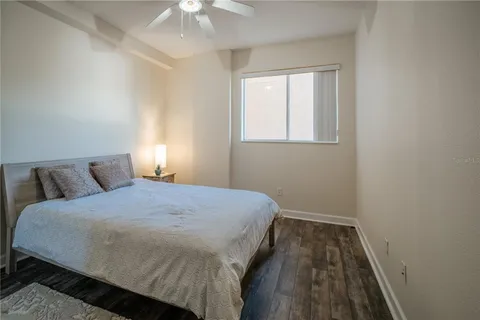 a bed room with a bed and a chair