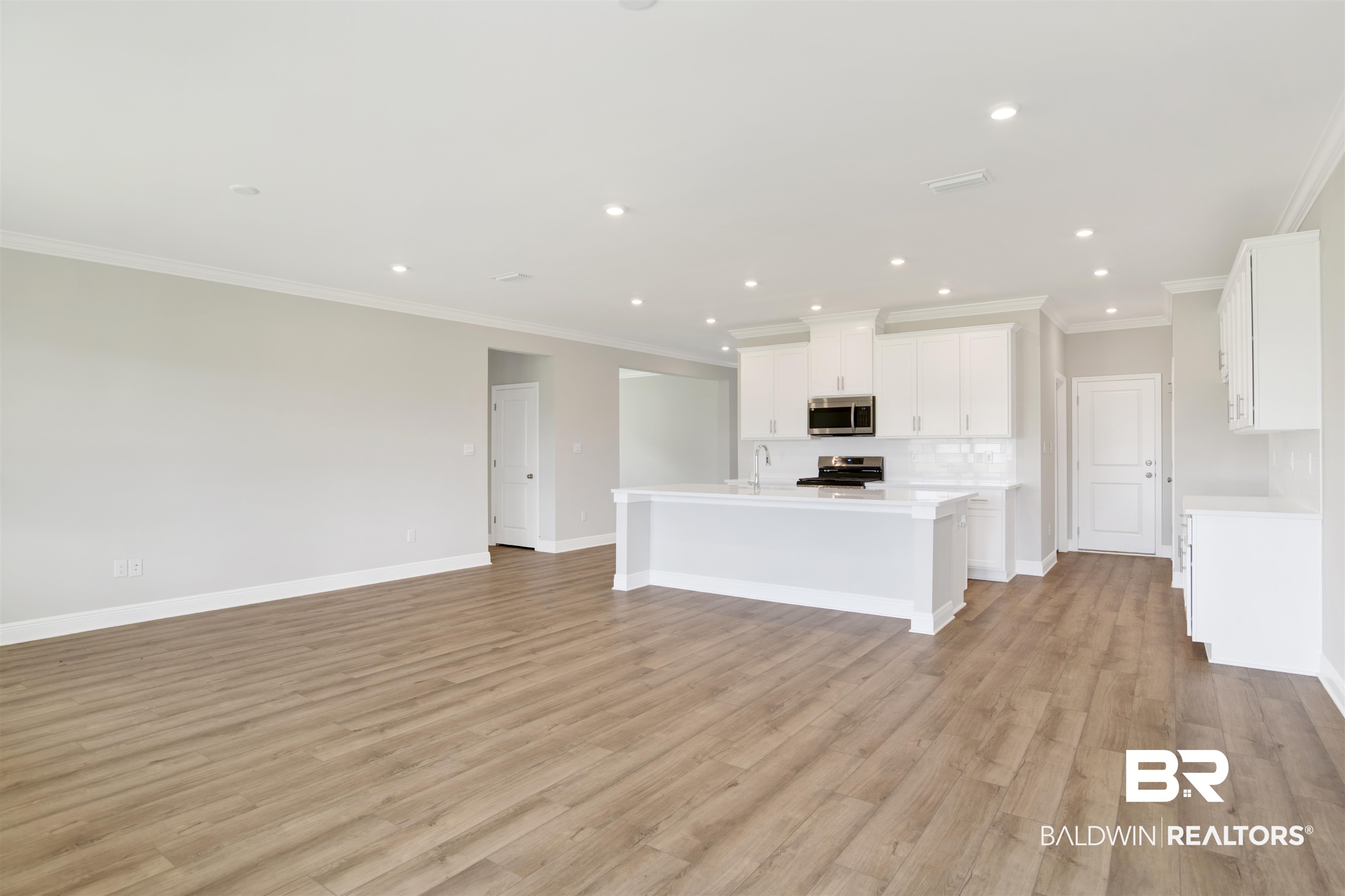 23852 Lafite Circle Daphne, AL 36526 - Photo 14 of 30 Unfurnished living room featuring crown molding, light wood-style flooring, and recessed lighting