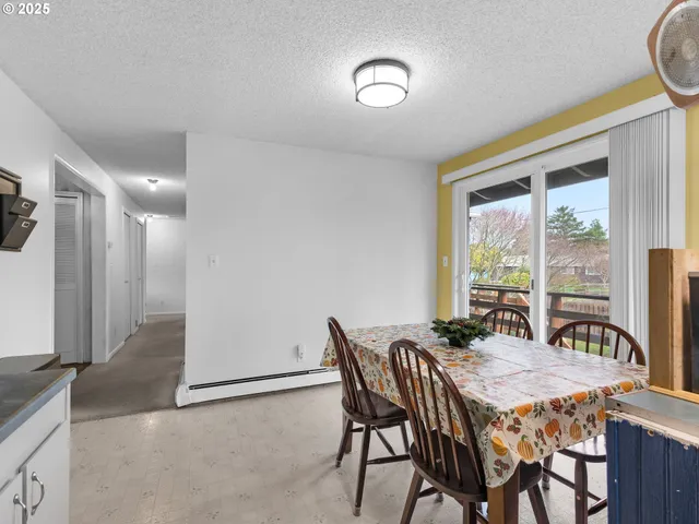a view of a dining room with furniture and a window