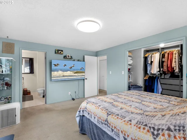 a bedroom with a bed and dresser