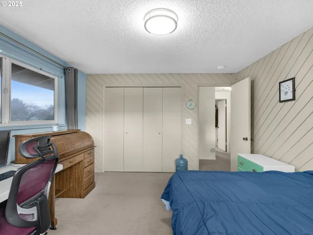 a bedroom with a bed and a mirror