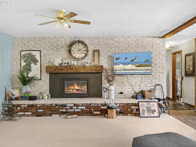 a living room with furniture a clock and a fireplace