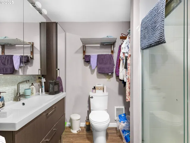 a bathroom with a sink toilet and shower