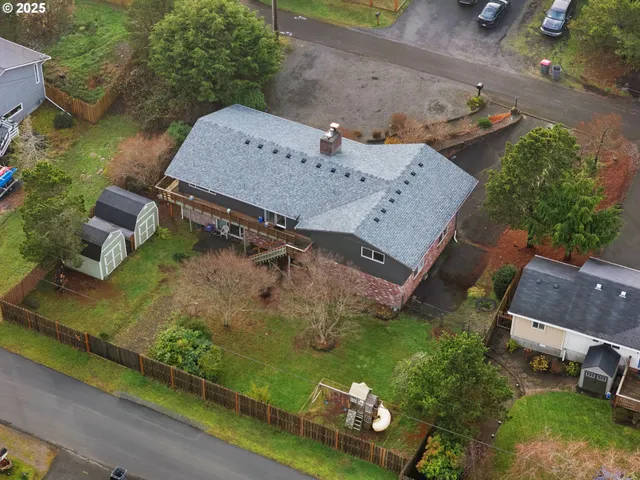 an aerial view of a house with a yard