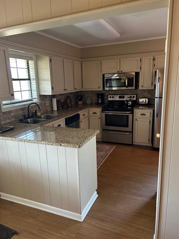 1000 Clark Street Mexia, TX 76667 - Photo 11 of 14 a kitchen with stainless steel appliances granite countertop a stove a sink and a refrigerator