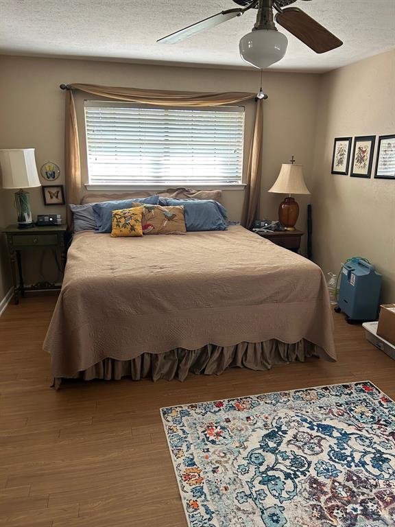 1000 Clark Street Mexia, TX 76667 - Photo 7 of 14 a bedroom with a bed and wooden floor