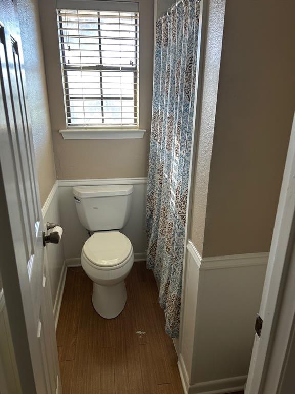 1000 Clark Street Mexia, TX 76667 - Photo 8 of 14 a white toilet sitting in a bathroom next to a window