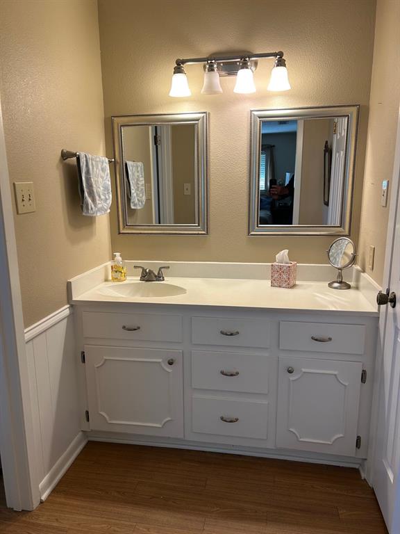 1000 Clark Street Mexia, TX 76667 - Photo 9 of 14 a bathroom with a double vanity sink and a mirror