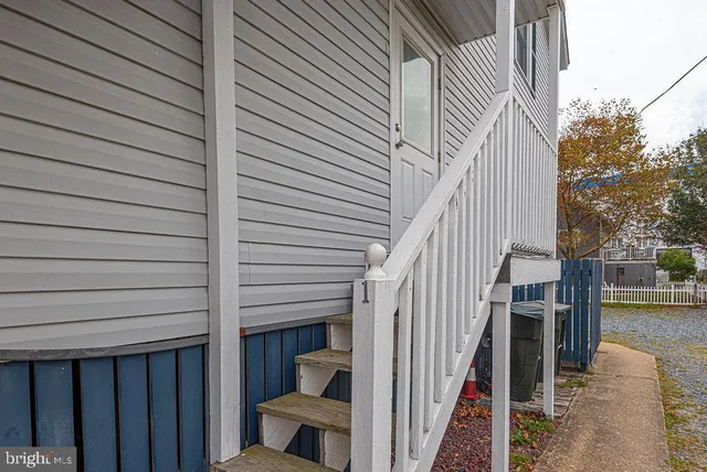 a living room with furniture a table and wooden floor