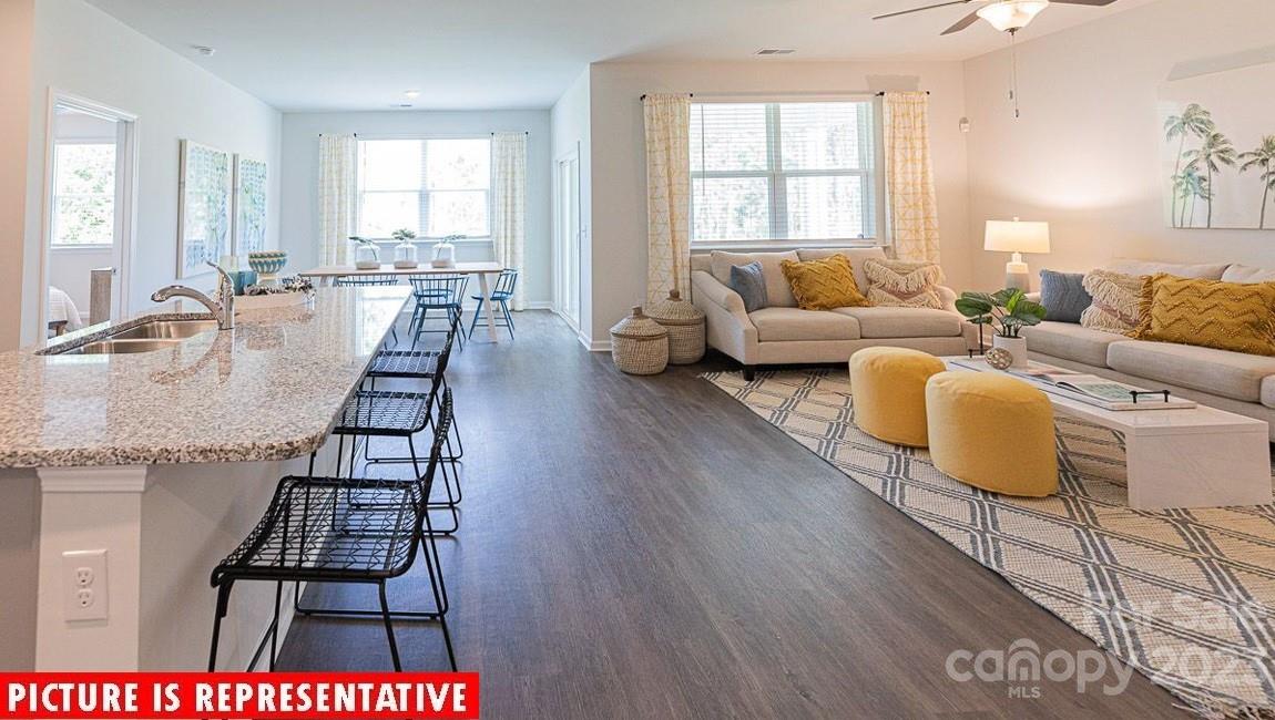 2047 Vanderlyn Street Monroe, NC 28112 - Photo 11 of 16 a living room with furniture dining table and a couch