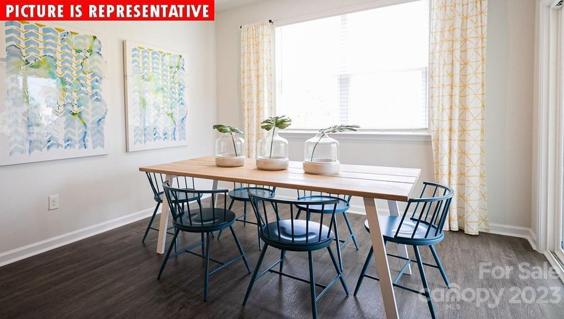 2047 Vanderlyn Street Monroe, NC 28112 - Photo 10 of 16 a view of a dining room with furniture window and wooden floor
