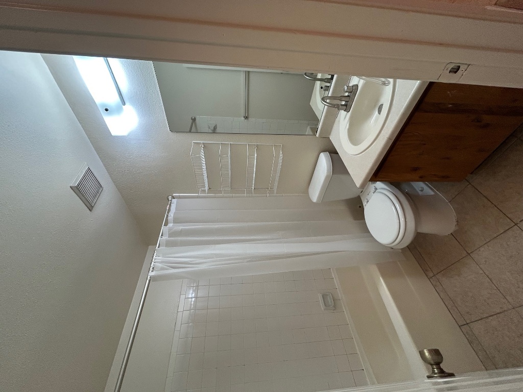 4600 Brown Bark Place, Unit A Austin, TX 78727 - Photo 11 of 18 a bathroom with a sink a toilet and shower
