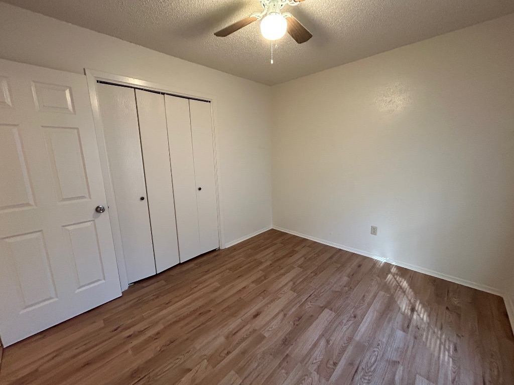 4600 Brown Bark Place, Unit A Austin, TX 78727 - Photo 15 of 18 a view of an empty room with wooden floor