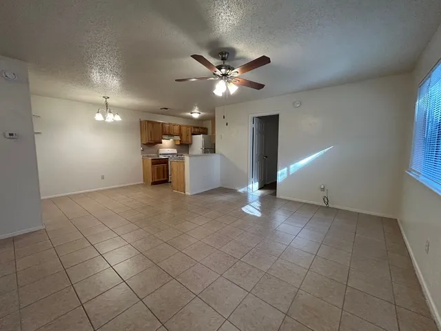 a view of a livingroom with a ceiling fan and window
