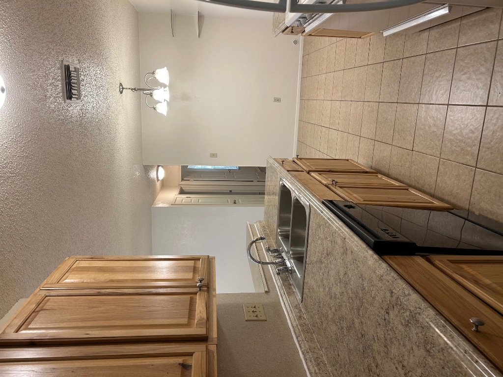 4600 Brown Bark Place, Unit A Austin, TX 78727 - Photo 7 of 18 a kitchen with a sink and cabinets