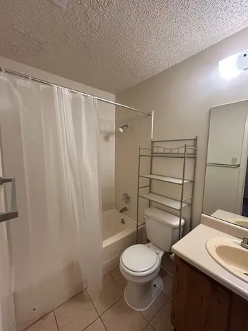 a bathroom with a toilet a sink and shower