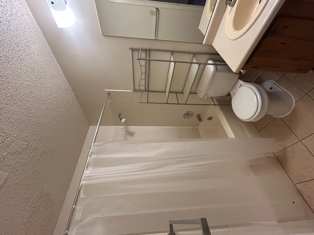 4600 Brown Bark Place, Unit A Austin, TX 78727 - Photo 10 of 18 a bathroom with a toilet a sink and shower