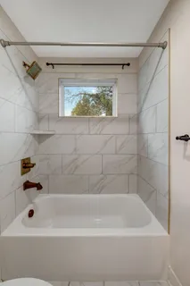 a bathroom with a bathtub and a shower