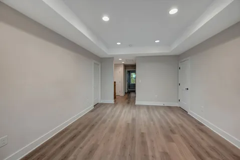 a view of an empty room with wooden floor