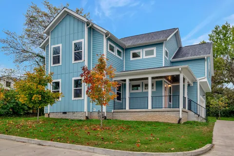 a front view of a house with a garden