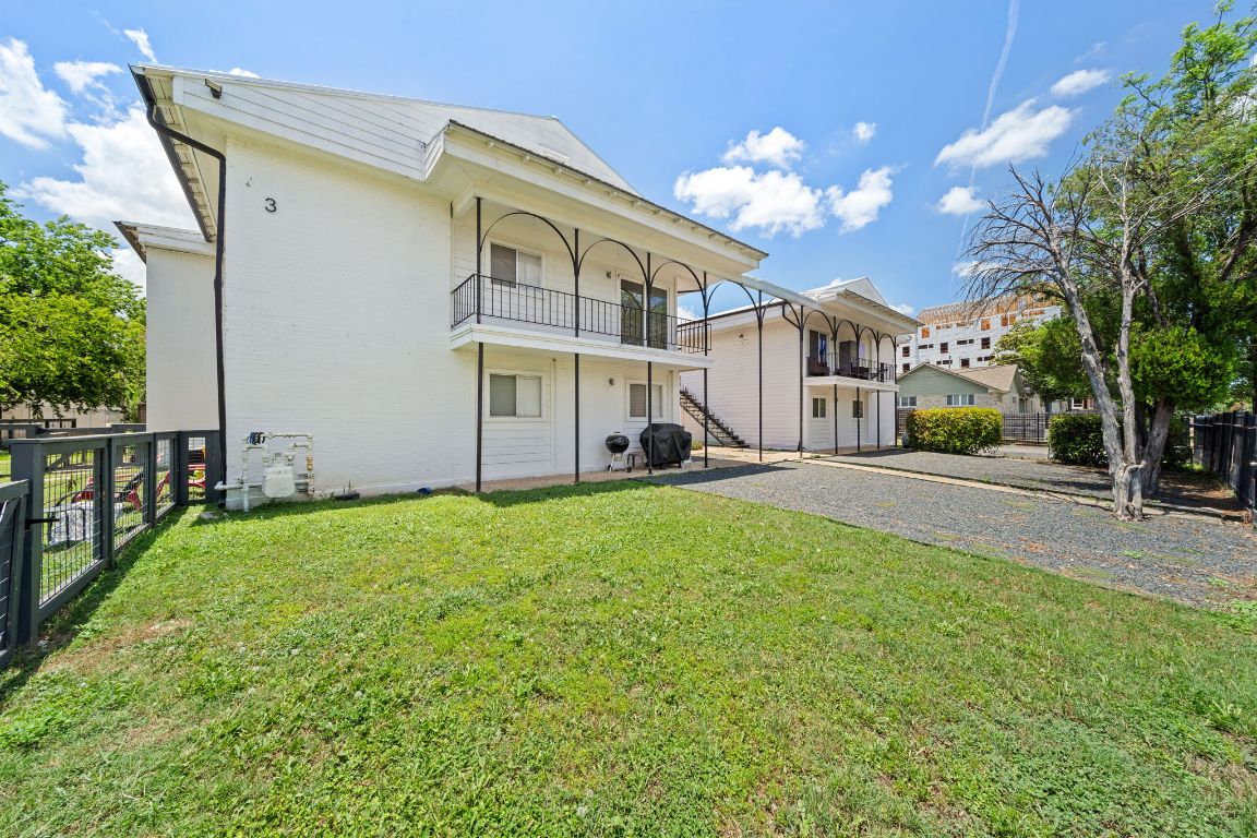 1313 East 52nd Street, Unit 205 Austin, TX 78723 - Photo 1 of 16 a view of a house with a big yard plants and large trees