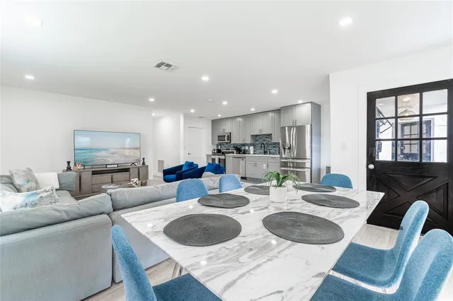 a kitchen with white cabinets sink and stainless steel appliances