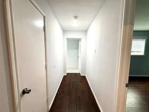 a view of a hallway with a dining room