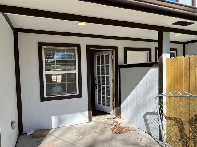 a view of a bedroom with wooden floor and windows