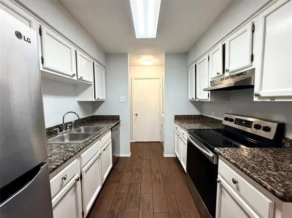 a kitchen with stainless steel appliances granite countertop a stove and a sink