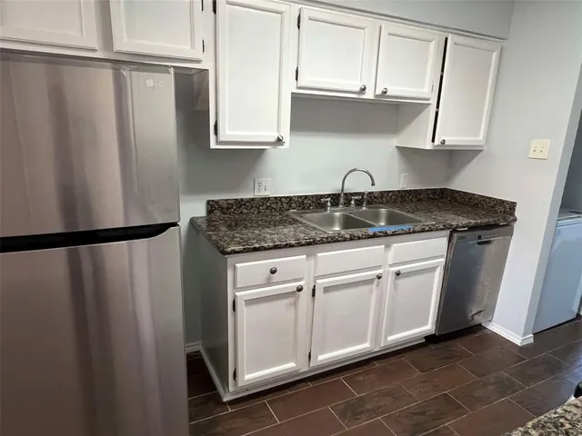 a kitchen with stainless steel appliances granite countertop a refrigerator sink and cabinets