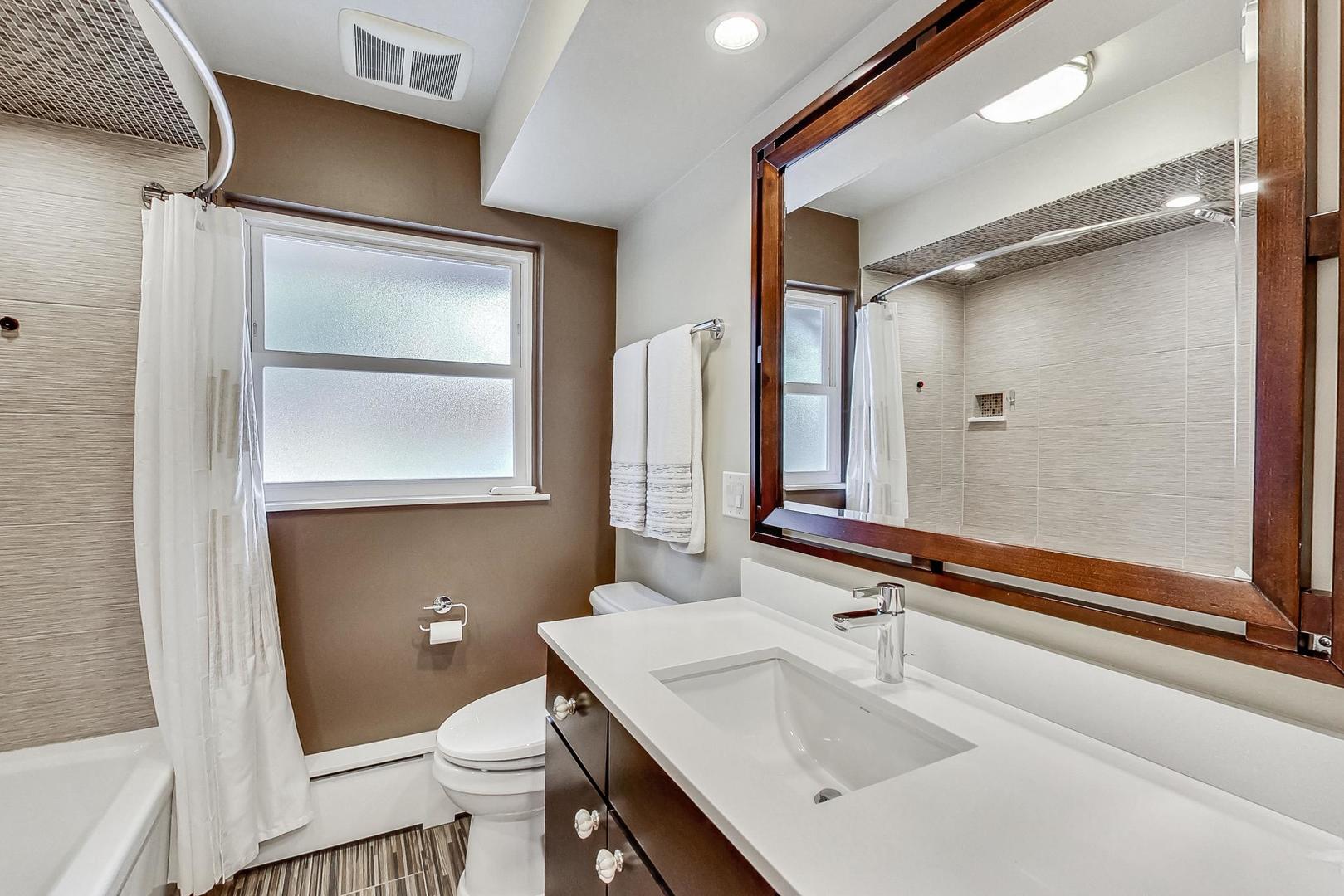 1314 Tyrell Avenue Park Ridge, IL 60068 - Photo 15 of 25 a bathroom with a sink a toilet a mirror and shower