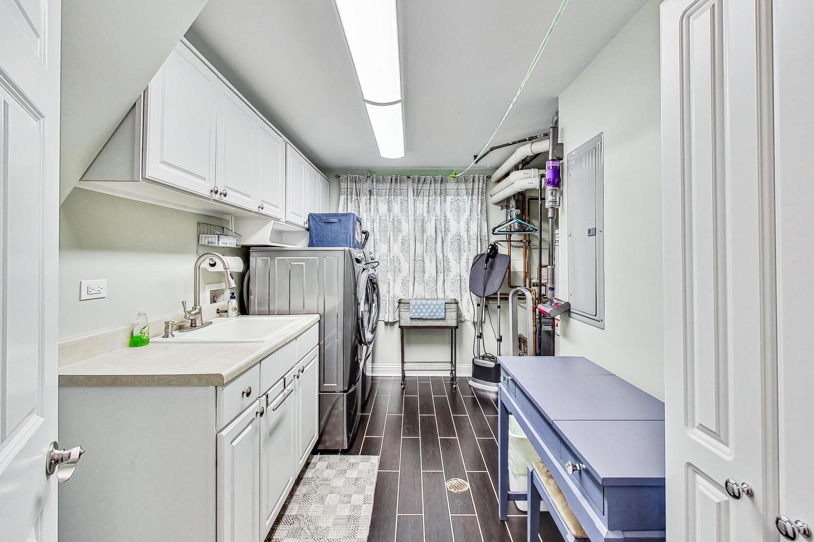 1314 Tyrell Avenue Park Ridge, IL 60068 - Photo 18 of 25 a storage room with cabinets washer and dryer