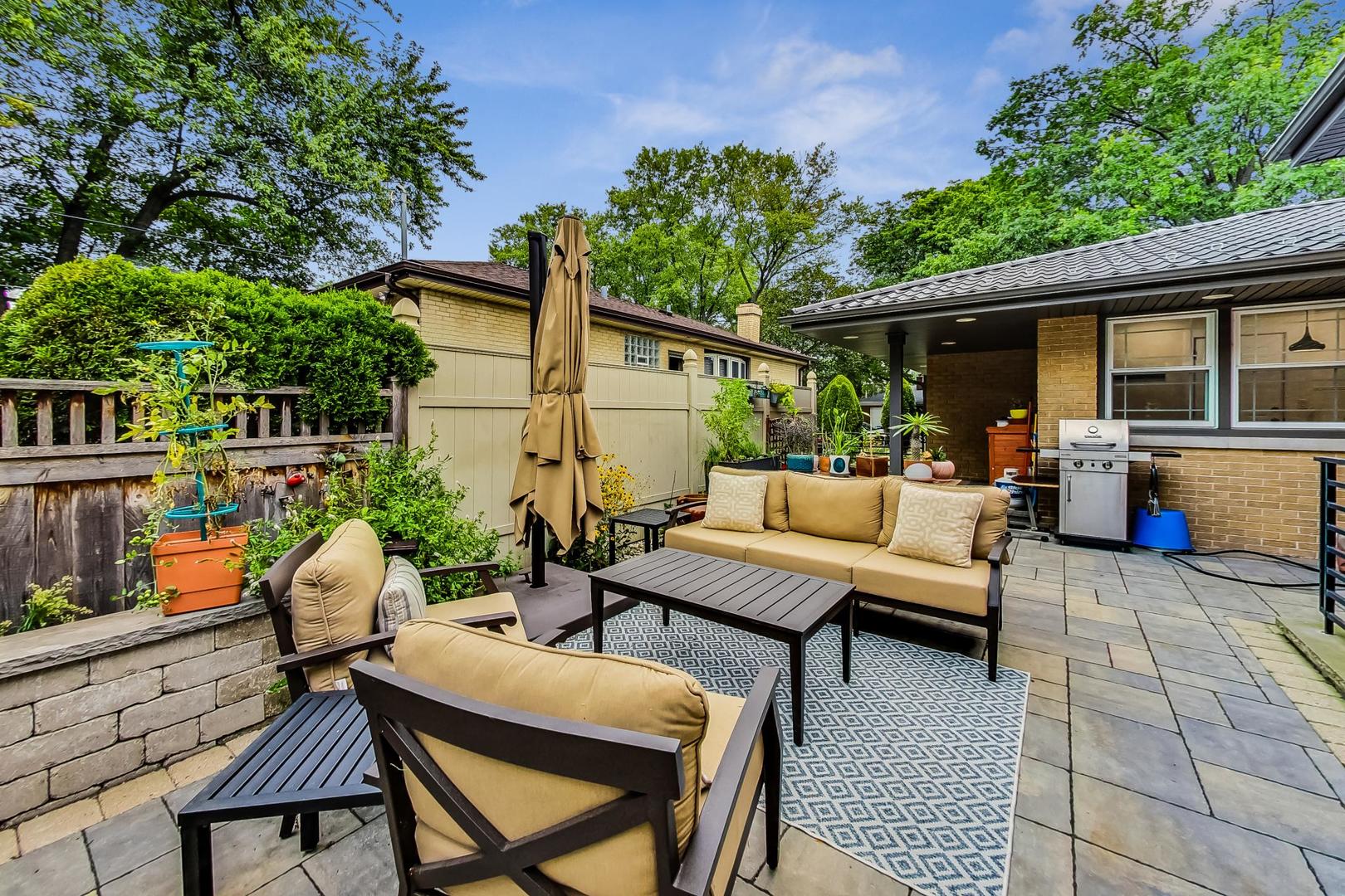1314 Tyrell Avenue Park Ridge, IL 60068 - Photo 22 of 25 a view of a patio with a table and chairs potted plants and a large tree
