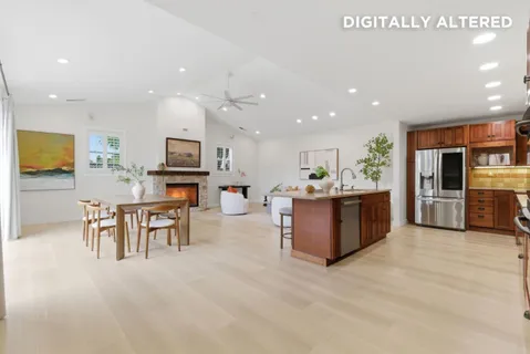 a kitchen with stainless steel appliances kitchen island granite countertop a sink and cabinets