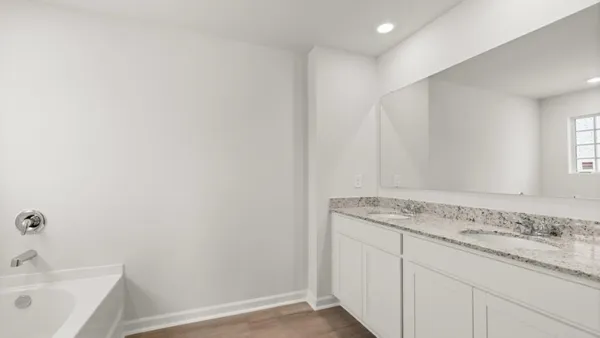 a bathroom with a granite countertop sink and vanity