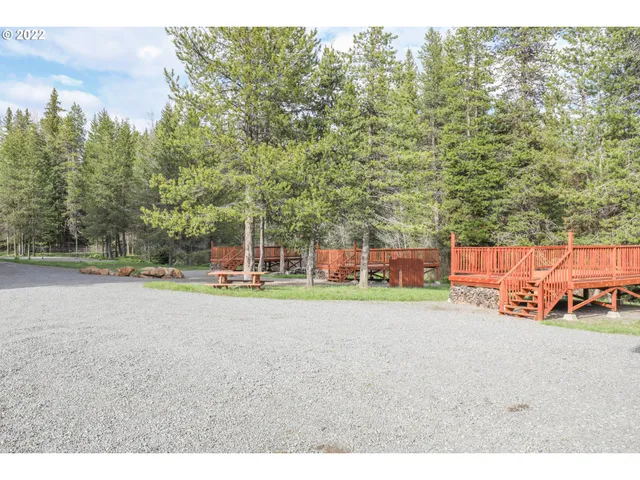 a view of a swimming pool and trees in the background