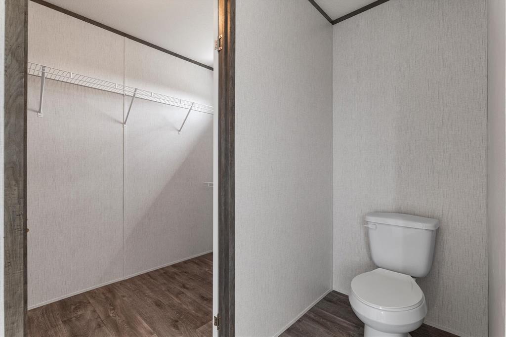 3888 Sandusky Road Whitesboro, TX 76273 - Photo 22 of 39 Bathroom featuring toilet and wood finished floors