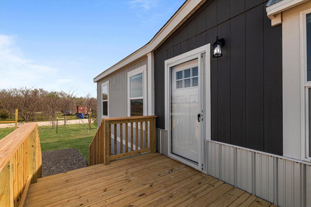 3888 Sandusky Road Whitesboro, TX 76273 - Photo 6 of 39 Wooden deck featuring a lawn