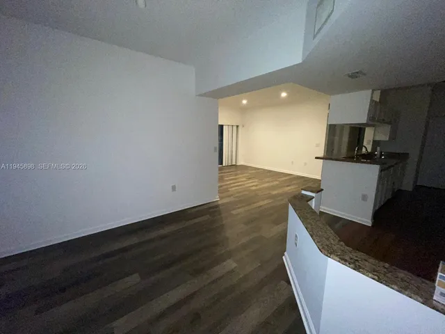 a living room with hard wood floors and a fireplace