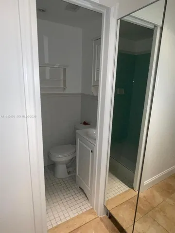 a bathroom with a toilet a sink and a mirror