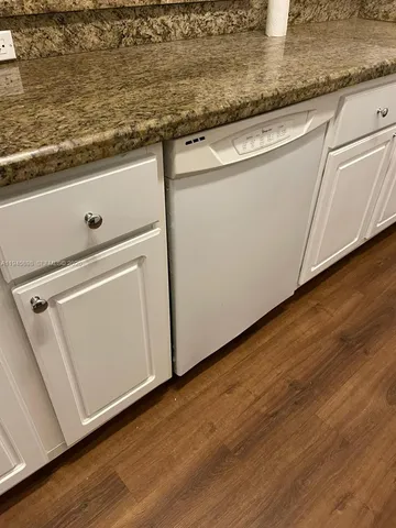 a close view of kitchen island with wooden floor
