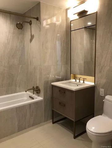 a bathroom with a sink mirror vanity and toilet