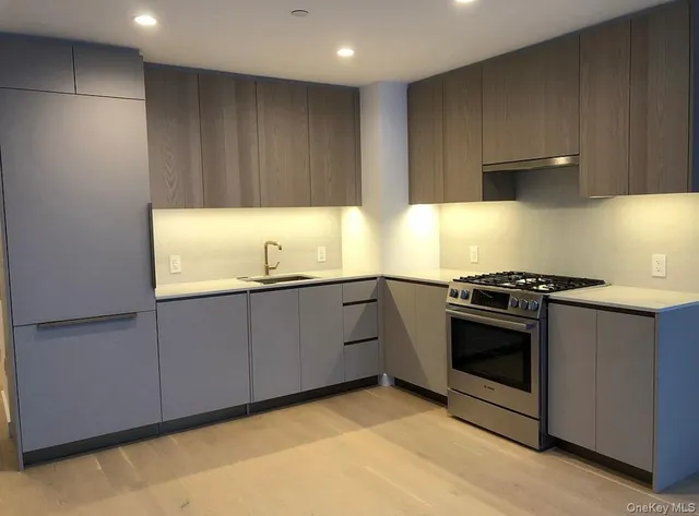 a kitchen with wooden cabinets and a stove top oven