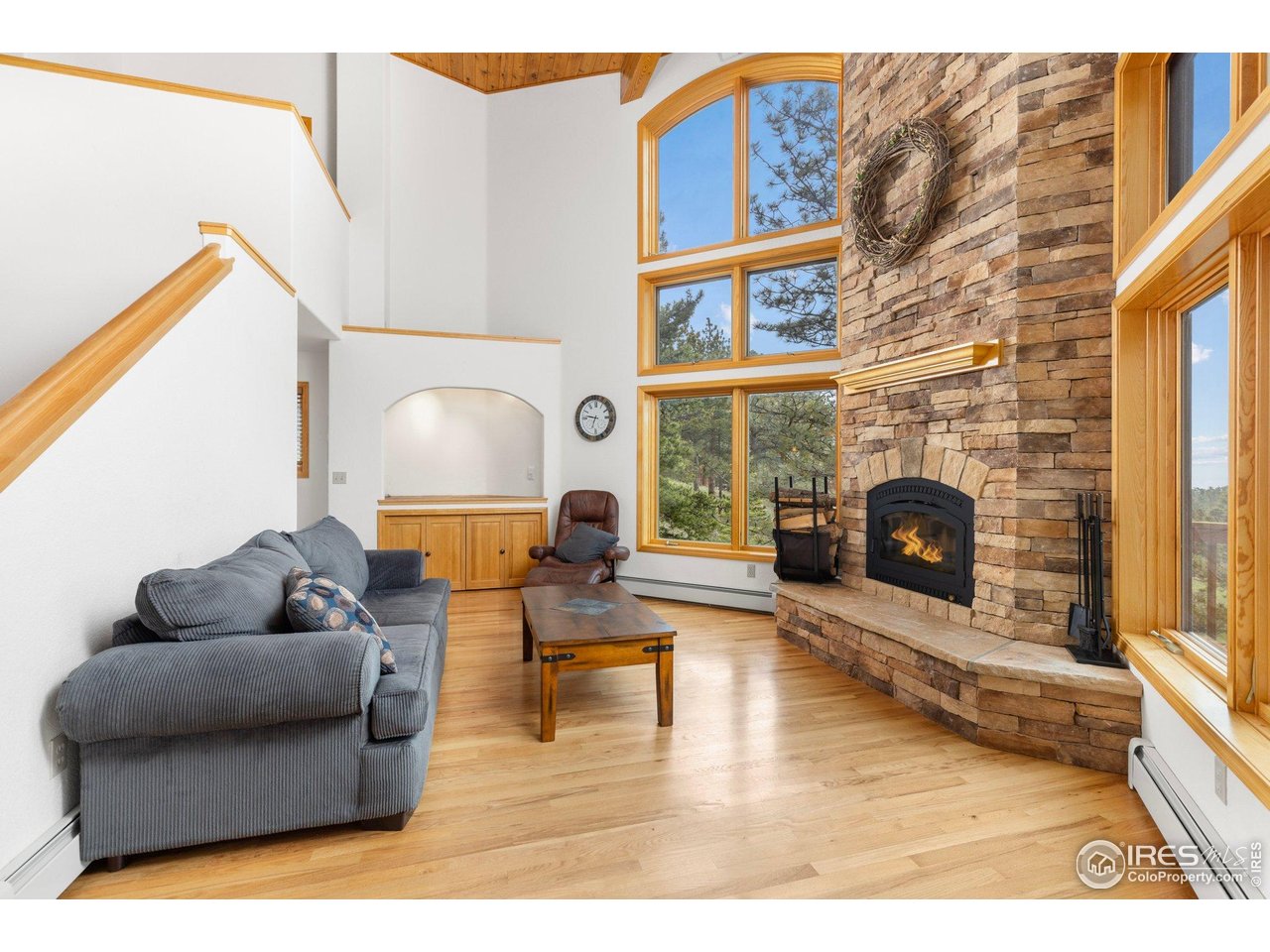 1117 Rock Lake Road Ward, CO 80481 - Photo 16 of 40 Living room with stone fireplace and amazing views and natural light