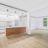 a view of kitchen with wooden floor and electronic appliances