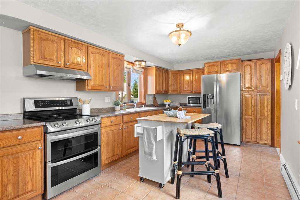 3 Scotland Heights Road Haverhill, MA 01832 - Photo 8 of 36 a kitchen with stainless steel appliances granite countertop a stove refrigerator sink and cabinets