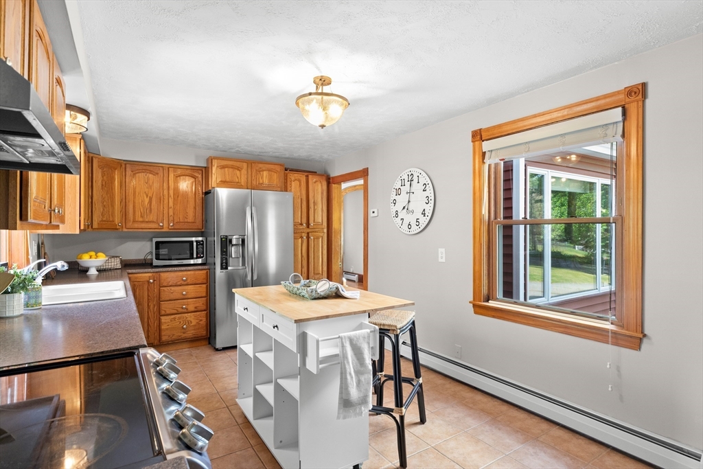 3 Scotland Heights Road Haverhill, MA 01832 - Photo 9 of 36 a open kitchen with stainless steel appliances granite countertop a refrigerator a sink dishwasher a stove with white cabinets and wooden floor