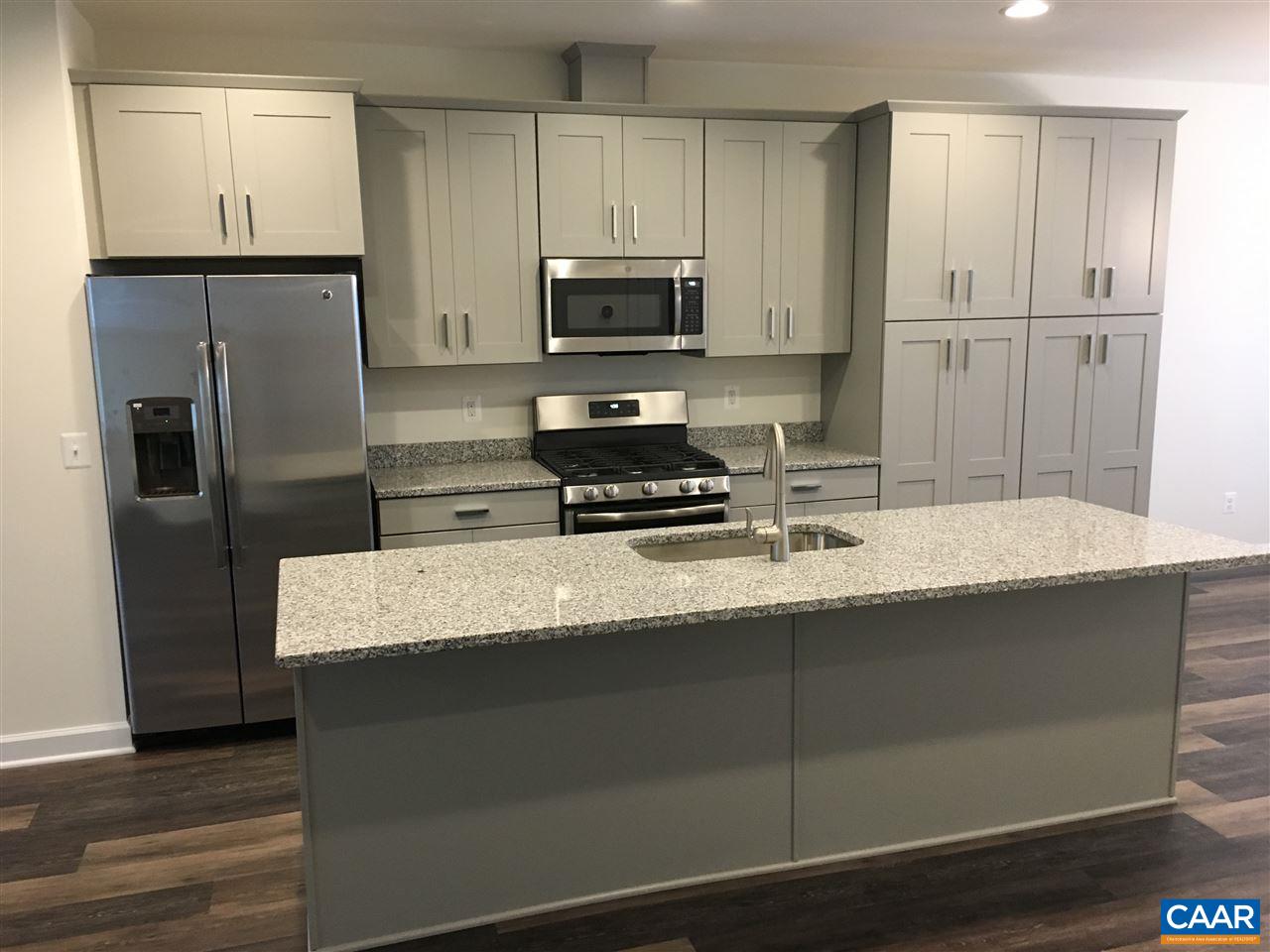 125 Junction Lane Charlottesville, VA 22902 - Photo 3 of 16 a kitchen with granite countertop a refrigerator a sink and wooden cabinets