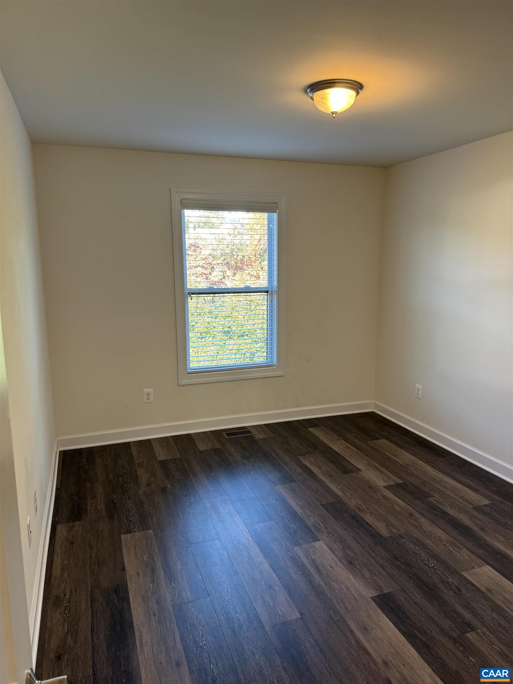 125 Junction Lane Charlottesville, VA 22902 - Photo 8 of 16 an empty room with wooden floor and windows