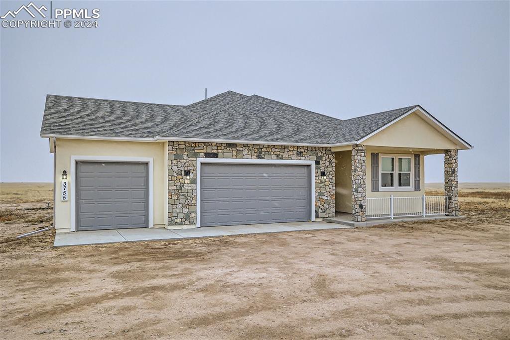 3755 North Rush Road Rush, CO 80833 - Photo 1 of 26 a front view of a house with a garage